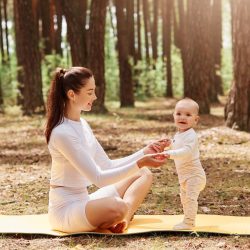 happy-smiling-female-white-trendy-sportswear-sitting-gym-mat-outdoor-holding-kids-palms happy-smiling-female-white-trendy-sportswear-sitting-gym-mat-outdoor-holding-kids-palms