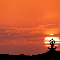 sunset-landscape-with-girl-practicing-yoga-hill
